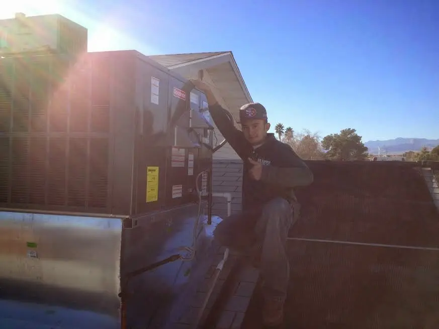 HVAC technician performing HVAC Inspection on a rooftop unit in North Mankato